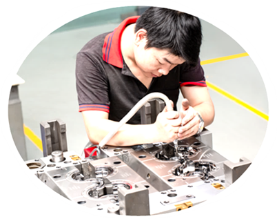 Technician assembling and checking an injection mould